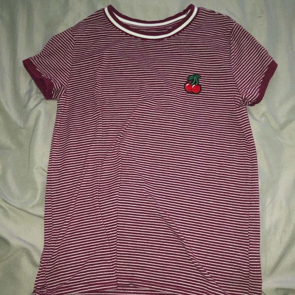 small red and white striped shirt with a patch